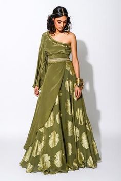 Olive green one shoulder kurta with fringe and coin detail on the neckline. Comes with foil print lehenga and embroidered belt. Component: 3 Pattern: Print Type Of Work: Foil Print, Mirror, Fringe and Coins Neckline: One Shoulder Sleeve Type: Full Fabric: Foiling Georgette and Crepe; Lining: Taxo Color: Green,Gold Other Details:  Kurta with asymmetrical hem Embroidered belt with front detail Occasion: Destination Wedding - Aza Fashions Rishi Vibhuti, One Shoulder Kurta, Kurta With Skirt, Kurta Lehenga, Sangeet Outfit, Ankara Dress Styles, Green Lehenga, Gaun Fashion, Embroidered Belt