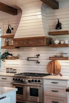 a stove top oven sitting inside of a kitchen next to wooden shelves and drawers on the wall