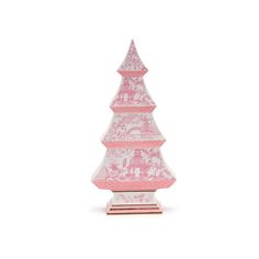 a pink and white ceramic christmas tree on a stand with an ornament in the shape of a pyramid