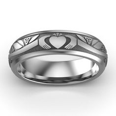 TITANIUM Claddagh Wedding Ring ASI-UCL2-TITAN6M Titanium Claddagh Wedding Ring Available in sizes from 6 through 13Available also in 10K Gold, 18K Gold, Platinum, White Gold, Yellow Gold, or Rose Gold. Our Titanium Claddagh Wedding Ring displays one Claddagh icon - hands, heart, and crown, 6 interwoven trinity knots, and 1 Celtic Rose knot. The length of the branch is tailored to the size of the ring, giving a smaller appearance to the corresponding smaller size. Our Titanium Claddagh rings offe Symbolic Hallmarked Wedding Rings, Symbolic Wedding Rings Hallmarked, Symbolic Engraved Wedding Ring, Symbolic Wedding Engraved Ring, Symbolic Polished Wedding Jewelry, Symbolic Wedding Jewelry With Polished Finish, Symbolic Polished Jewelry For Wedding, Silver Hallmarked Couple Rings For Wedding, Silver Ring With Halo Design For Marriage