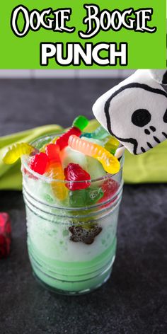 an odd looking drink with gummy bears in it and the words oogie boogie punch