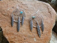 These are a beautiful Handcrafted Native American Made Sterling Silver Turquoise Dream Catcher Pair Of Earrings. Each pair of earrings are entirely Handcrafted which makes it a ONE OF A KIND. Theses earrings that I sell are meticulously handcrafted by Native Americans, and the quality and attention to detail is truly exceptional. The hand weaving of the dream catcher is amazing.  These would make a lovely gift or a great addition to your own collection! They are a nice larger size but still light enough for all day wear! Please look at the photos for size. The artist is, Doreen Leyba and she is part of the San Felipe tribe. The San Felipe Tribe is nestled between Santa Fe and Albuquerque, the Pueblo of San Felipe consists of approximately 3,700 enrolled tribal members and approximately 68, Earrings With Feathers, Heishi Jewelry, Turquoise Dream Catcher, Dream Catcher Earrings, Silver Turquoise, Turquoise Sterling Silver, American Made, Beautiful Hand, Sterling Silber