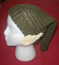 a crocheted hat on top of a white mannequin head