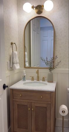 a bathroom with a sink and mirror in it