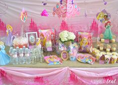 there is a table with princess themed items on it