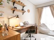 a desk with a laptop computer on top of it next to a chair and window