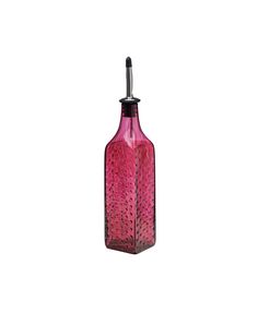 a pink glass bottle sitting on top of a table