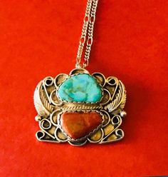 This 1970's classic floral overlay Native American made sterling silver natural blue turquoise stone and natural coral and sterling silver square pendant/brooch is a wonderful classic. The pendant is 1 1/2 inches tall and 1 5/8 inches wide. It is signed sterling and hallmarked GY on the back. I paired it with a sturdy 23 inch silver tone (NOT sterling) chain just so you can have a ready chain. This fabulous vintage brooch. I specialize in finding fun wearable jewelry. Please browse my shop for m Vintage Multi-stone Necklaces For Gifts, Vintage Multi-stone Necklace For Gift, Rectangular Turquoise Jewelry For Collectors, Vintage Multi-stone Pendant Necklace, Collectible Rectangular Turquoise Jewelry, Turquoise Multi-stone Pendant Necklace As Gift, Silver Multi-stone Turquoise Necklace Gift, Silver Multi-stone Turquoise Necklace As A Gift, Vintage Pendant Jewelry With Natural Stones