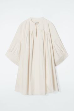 This modern tunic feels at home on long summer days, with its relaxed shape and lightweight cotton-blend fabric. It's designed with a subtle V-neck, wide cuffs and irregular pleats that lend volume. Style it as a mini dress or layer over pants for an effortless look. Relaxed fitSide-seam pockets Shell: 65% Cotton, 30% Polyamide, 5% Elastane. Excluding trims / Machine wash Back length of size 6 is 35.74" / Model wears a size 6 Oversized Pleated Spring Dress, Summer Dresses With Pleated Sleeves In Relaxed Fit, Summer Dresses With Pleated Sleeves And Relaxed Fit, Oversized Pleated Summer Dress, Oversized Pleated Dresses For Summer, Spring Elegant Oversized Tunic, Spring Pleated Dress With Gathered Sleeves, Oversized Summer Tunic For Workwear, Oversized Summer Workwear Tunic