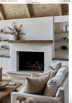 a living room filled with furniture and a fire place