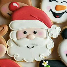 decorated cookies with santa claus and snowmen on them