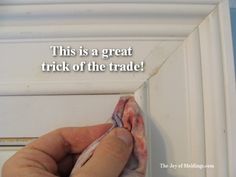 a person is painting the trim on a white door with a message that reads, this is a great trick of the trade