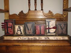 the word family spelled in vintage letterpresss on a wooden shelf above a piano