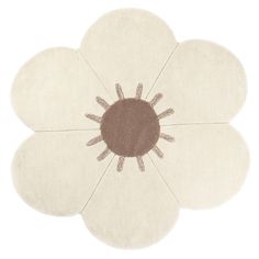 a white flower rug with brown center on the top and bottom, in front of a white background