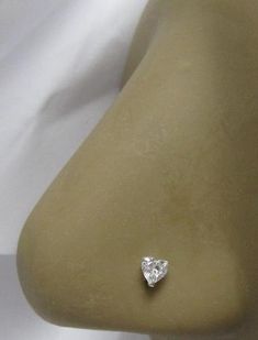 a white diamond is sitting on top of a mannequin