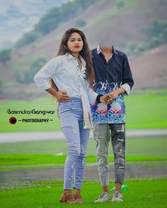 two young women standing next to each other in front of a green field with mountains