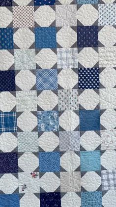 a blue and white quilt is on display