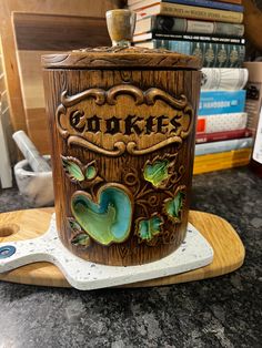 a cookie jar sitting on top of a cutting board