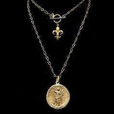 The light and airy Wisdom Chain Peace Angel Necklace is designed so it is long enough to be worn double wrapped. A noble fleur de lis graces the toggle so it shows when worn doubled, making this a wonderfully versatile necklace. The Peace Angel gives it an especially ethereal feel. The medal is easily removed for use on other necklaces. This regal holy medal features Theotokos (the Mother of God) with Archangel Gabriel on the opposite side Theotokos is another name for the Virgin Mary, and she a Trinity Necklace, Archangel Gabriel, Goddess Jewelry, Angel Jewelry, Angel Necklace, Medallion Necklace, Coin Jewelry, The Peace, Girl Stuff