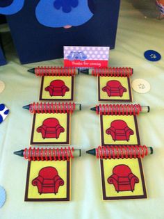 a table topped with lots of pencils next to a card and some cards on top of it