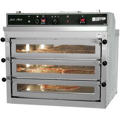 an industrial style pizza oven with four trays