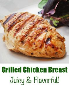 grilled chicken breast on a plate next to a salad