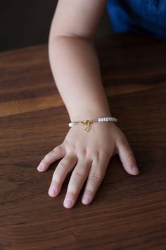 "If you would like to add gold filled hardware to a bracelet, please use this link to purchase it along with the bracelet. You will need to purchase one for EACH bracelet you would like to add gold filled hardware to. https://www.etsy.com/LittleLovliesShop/listing/860546443/gold-filled-upgrade?utm_source=Copy&utm_medium=ListingManager&utm_campaign=Share&utm_term=so.lmsm&share_time=1598757365437 Pretty white bracelet. Your choice of gold or silver clasp and fittings. Perfect to co Toddler Bracelet, Baby Blessing, Baby Jewelry, White Bracelets, Simple Bracelets, Star Bracelet, Beading Wire, Accessories Unique, Delicate Bracelet