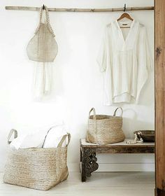 a white room with two baskets and a coat rack