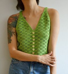 Introducing our Crochet Summer Top for Women, a perfect blend of boho style and festival-ready charm, ideal for warm weather adventures. Ready to ship 100% Handmade (hand knit) SIZE: M * 12/14 UK Sizes; * 8/10 USA Sizes; * 40/43 Europen Sizes Please look at the actual measurements in description which are taken by hand and thus show the actual size. Measurements ( laying flat): Total length: 44 cm / 17,32 in Chest: 92 cm / 36,22 in COLOR: green MATERIAL: 100% cotton wooden buttons Shipping* I sh Bohemian Cotton Knit Top For Summer, Knit Crochet Top For Summer, Cotton Crochet Top For Spring Festival, Bohemian Knit Top For Summer, Fitted Cotton Crochet Top, Summer Crochet Tops For Festival, Handmade Fitted Crochet Top For Spring, Fitted Cotton Crochet Top For Spring, Cropped Cotton Knit Top