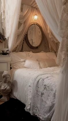 a white bed sitting in a bedroom next to a mirror