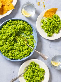 guacamole in a bowl with tortilla chips on the side