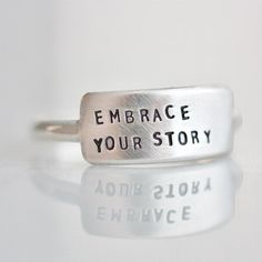 "The Cherished inspiRING makes for the perfect everyday ring that features your favorite little reminder. Designed to be the little sister to the wide inspiRING, this ring will be one you cherish for years to come. Letters are individually stamped by hand, making each ring one of a kind. The message is left justified in our signature teeny-tiny upper case block font. Choose one of our messages https://www.etsy.com/listing/896792268 or create your own. details + message plate measures 5/8\" wide Inspirational Adjustable Sterling Silver Rings, Adjustable Inspirational Sterling Silver Rings, Adjustable Inspirational Rings For Everyday, Meaningful Silver Stackable Rings, Meaningful Hand Stamped Stackable Promise Rings, Minimalist Hand Stamped Midi Rings, Adjustable Sterling Silver Stackable Rings, Minimalist Hand Stamped Stackable Rings As Gift, Minimalist Hand Stamped Stackable Rings For Gift