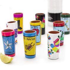 the shot glasses are lined up in different colors and designs, including one with a star on it