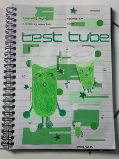 a spiral notebook with an image of two green cats on it and the words treat cube written in white