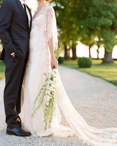 a bride and groom pose for a wedding photo