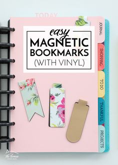 the magnetic bookmarks with vinyl are on top of a pink binder and next to each other