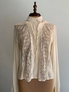 "Vintage blouse from the 1930s. Entirely hand stitched, very delicate and quality is immaculate. Chantilly lace, silk crepe, mother of pearl buttons. Pit to pit: 19\" Neck across: 6\" Length: 21\" Sleeve length from shoulder: 24\"" Vintage Silk Blouse, Elegant Lace Top For Day, Elegant Lace Work Blouse For Daywear, Elegant Lace Patchwork Blouse For Daywear, Classic Lace Tops With Lace Work, Silk Tops With Lace Trim For Daywear, Classic Lace Blouse, Classic Lace Tops With Lace Cuffs, Elegant Silk Blouse With Lace Trim