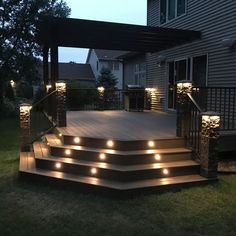 an outdoor deck with lights on the steps