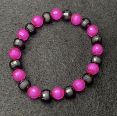 Material: clear string Color: pink and black beads Type: Bracelet Style: Glamorous Pink Crystal Bracelet With 8mm Beads For Party, Black Round Beads Bracelets For Party, Pink Beaded Party Bracelets, Trendy Black Beaded Bracelet With 8mm Beads, Black Beaded Stretch Bracelet For Party, Black Stretch Bracelet With Black Beads, Black Bracelet, Bracelet Style, Black Bracelets