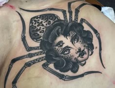 a man with a spider tattoo on his back