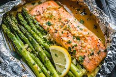 salmon and asparagus in foil with lemon wedges