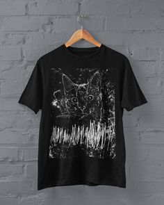 Grunge Cat T-shirt Printed on a super soft, cotton tee Dispatched in 5 working days or sooner Unisex Free UK delivery Material: 100% ringspun cotton. Chest (to fit): S  34/36   M  38   L  40/42   XL  44/46   XXL  48/50 ECO-FRIENDLY Each garment is made to order, reducing extra material and energy that would be otherwise wasted We use DTG printing process which is easier on the environment than screen-printing Our ink is bright and also eco-friendly. Do not tumble dry. Wash at 30 degrees c, insid Alternative Style Short Sleeve Screen Print Shirt, Alternative Style Pre-shrunk Crew Neck Shirt, Alternative Style Short Sleeve Pre-shrunk Shirt, Gothic Graphic Print Top For Concert, Alternative Crew Neck Shirt For Alternative Fashion, Alternative Style Graphic Print Relaxed Shirt, Alternative Style Crew Neck Shirt For Alternative Fashion, Alternative Style Pre-shrunk T-shirt, Alternative Style Pre-shrunk Short Sleeve Shirt