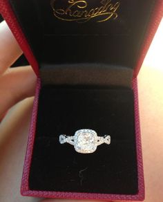 an engagement ring in a red velvet box