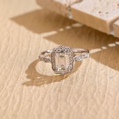 an engagement ring sitting on top of a wooden table