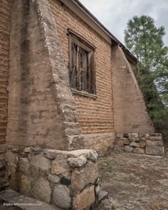 an old brick building with a window on the side