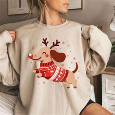 a woman wearing a christmas sweater with a dog on it