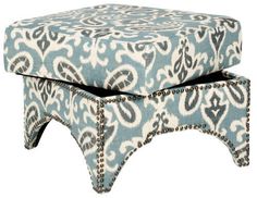 two blue and white ottomans with studded trim on the bottom, one is upholstered