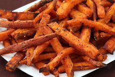 a white plate topped with french fries covered in seasoning