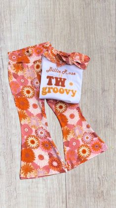 an orange and pink flowered leggings with a white t - shirt on it