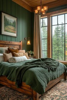 a large bed sitting in a bedroom next to a window covered in green blankets and pillows